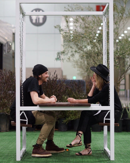 2-Seater SwingTable | Indoor with Wood Table, enjoyed by two people